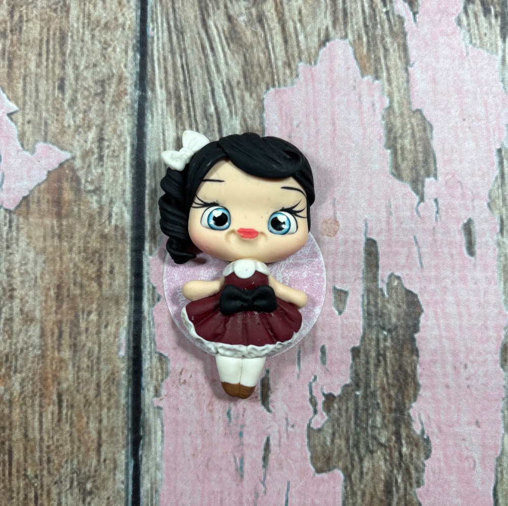 Little girl, burgundy and white ruffle dress, black hair blue eyes