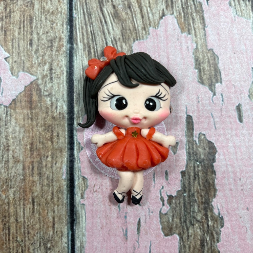 Little girl, orange dress, orange bow, dark brown hair, brown eyes
