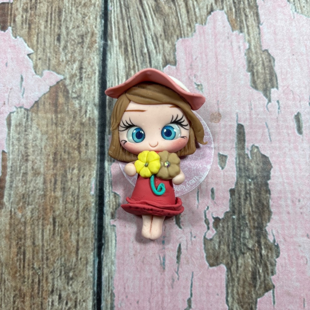 Little girl, red dress, pink hat with flowers, light brown hair, blue eyes