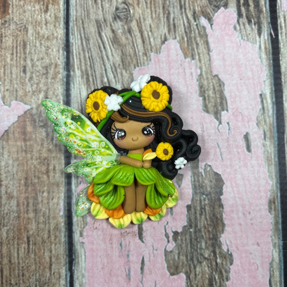 Fairy with green and orange dress, black hair, brown highlights and daisies in hair