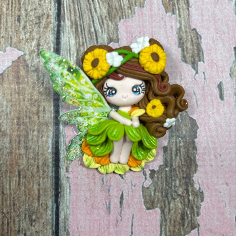 Fairy with green and orange dress, brown hair with sunflowers in hair