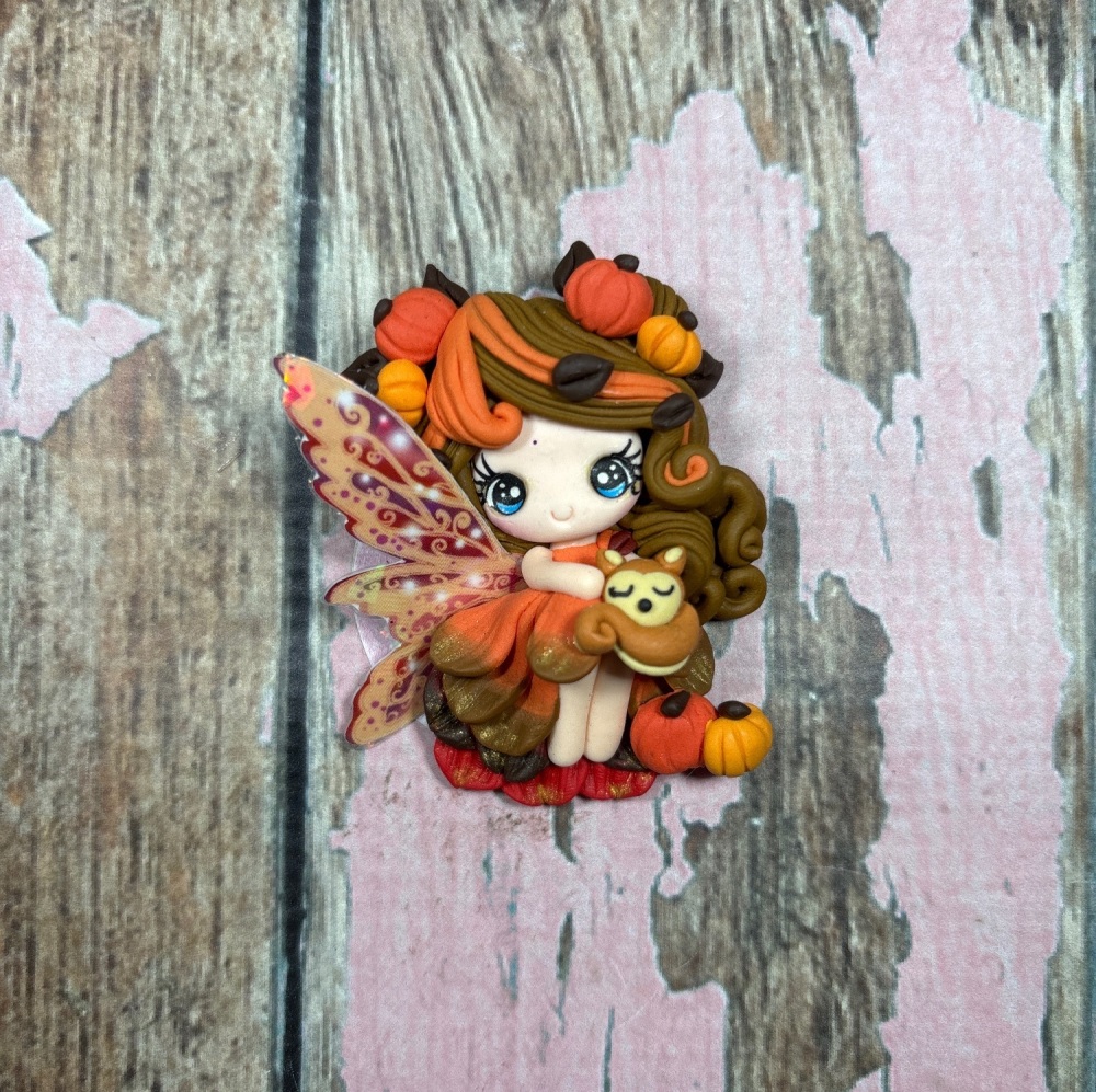 Fairy autumn season with pumpkins in her hair, brown and orange hair fox Friend