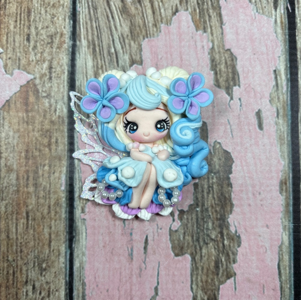 Fairy in blue dress, white and blonde hair, lilac and blue flowers with pearls