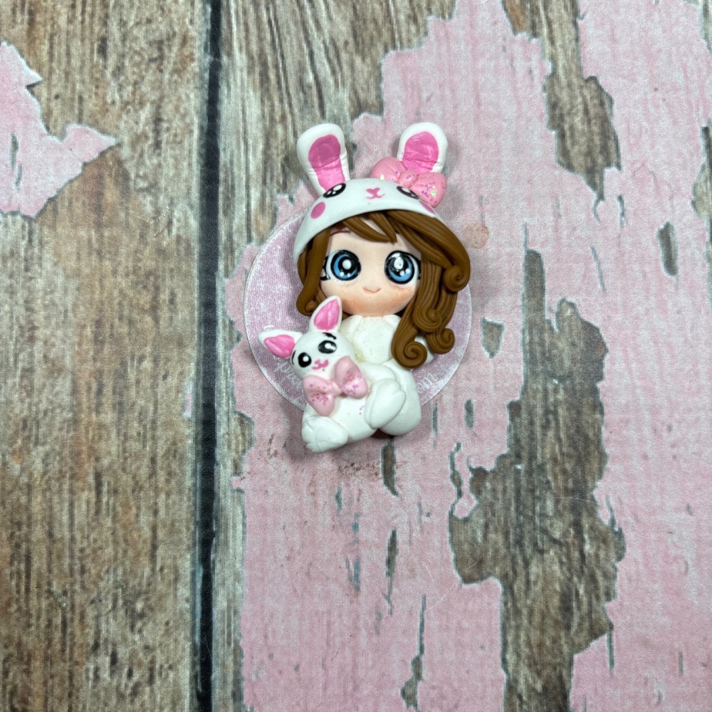 Little girl in bunny costume with pet rabbit brown hair