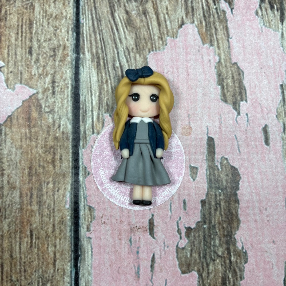 Little Girl in black and grey school uniform blonde hair and black bow