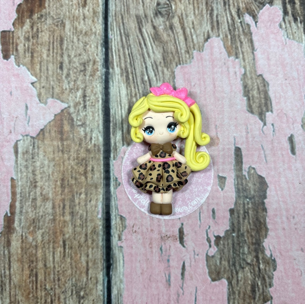 Little Girl with leopard print dress blonde hair and pink hair bow