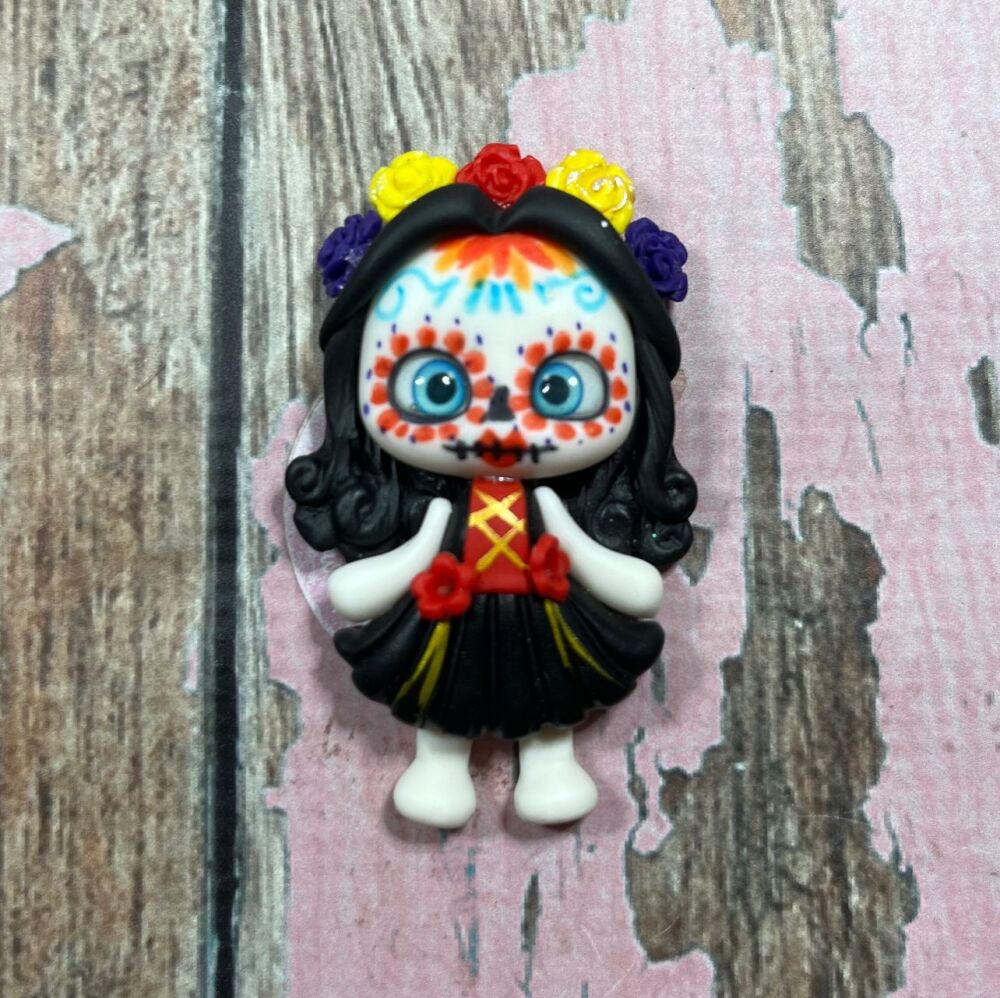 Big Girl with skeleton face paint, a black dress, has black hair and a flower headband