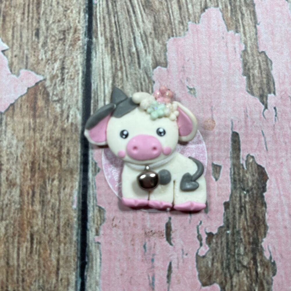 Little cow with flowers and a heart shaped tail