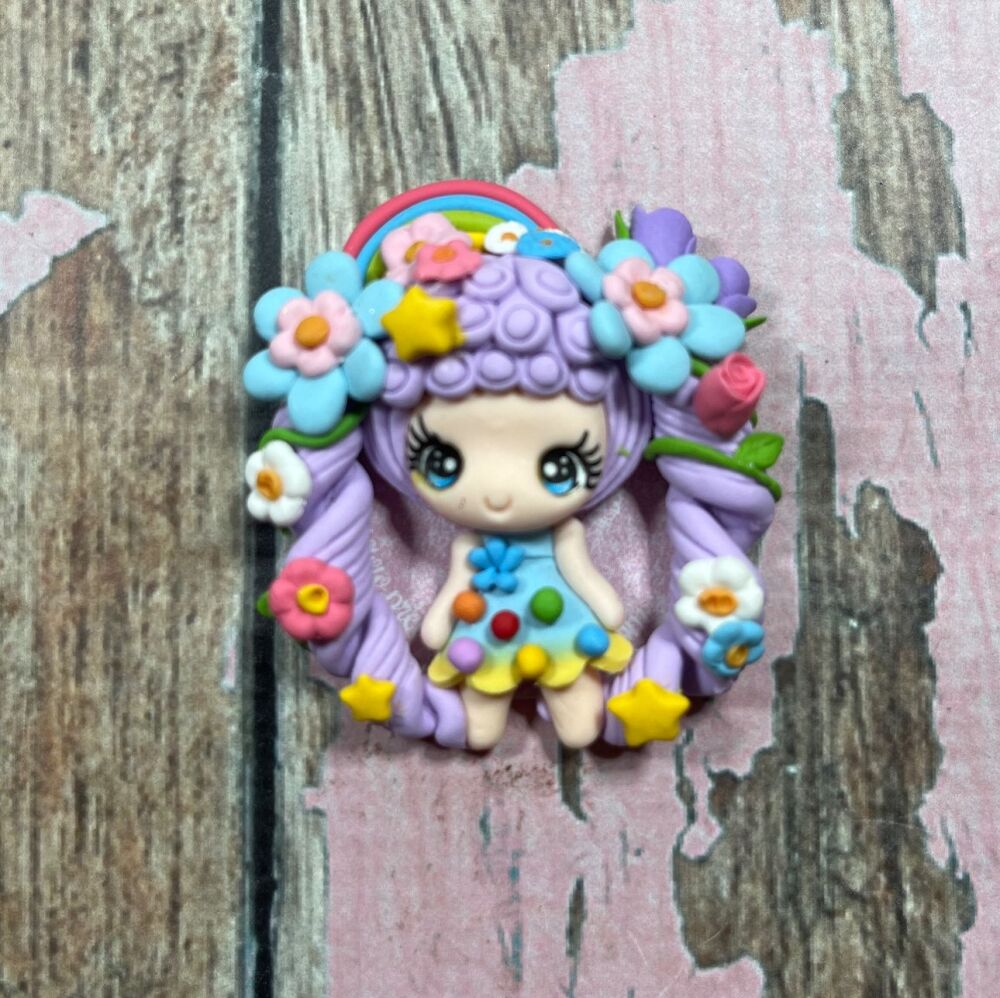 Big girl with purple hair and flowers in her hair, a light blue dress with colourful dots