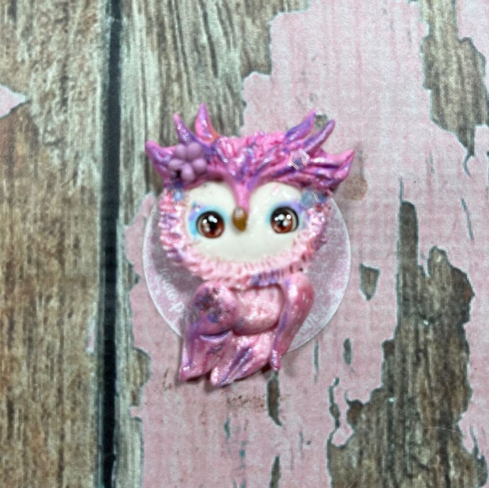 Little pink glittery owl with a purple flower