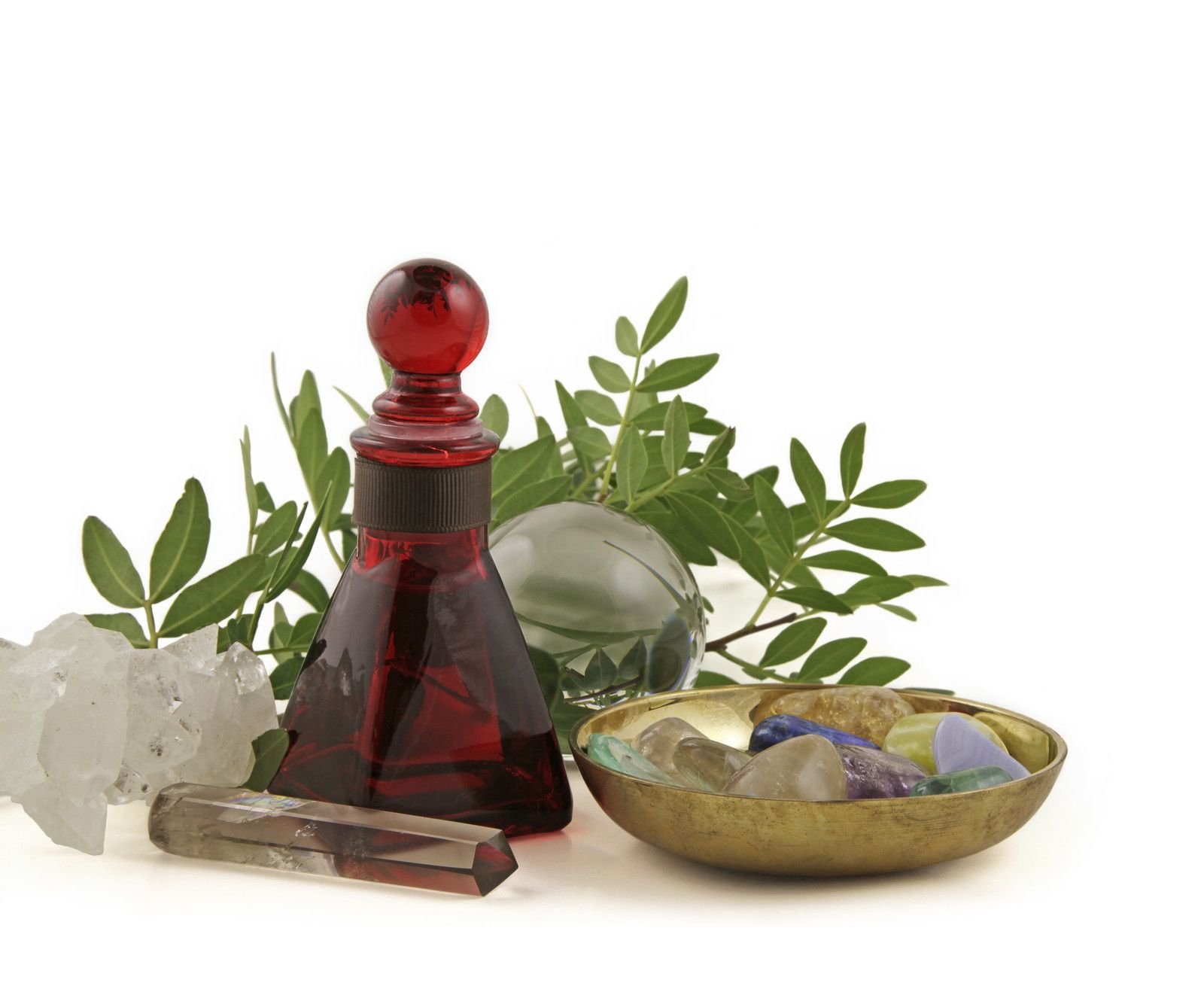 red bottle, massage wand and dish of crystals