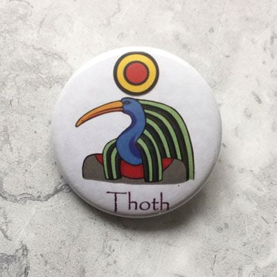 A round white badge with an image of Thoth.