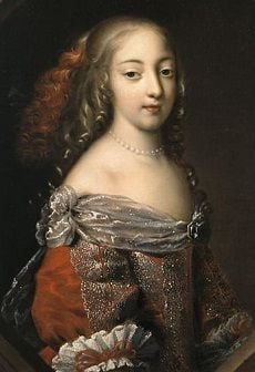 Athenais de Montespan with long curly hair, wearing a red and silver dress trimmed with lace