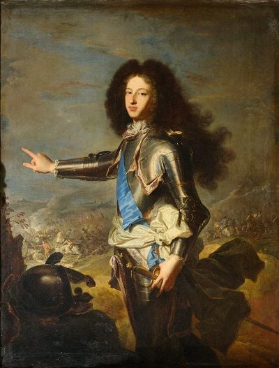 Louis, the Petite Dauphin, wearing armour and a blue sash, pointing to the left.