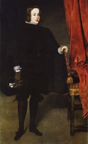 Balthasar Charles wearing black clothes with a red curtain in the background.