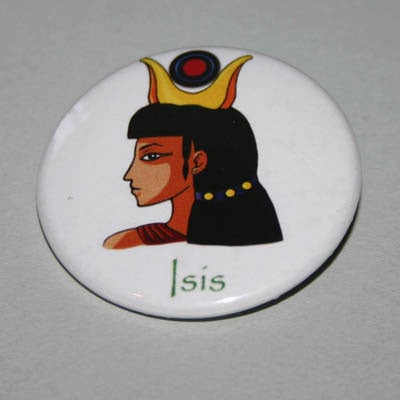 A round white badge with an image of the goddess Isis.