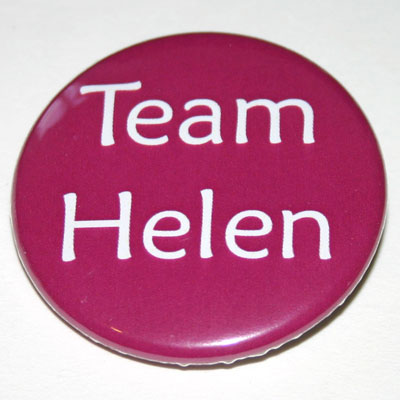 A round pink badge with 