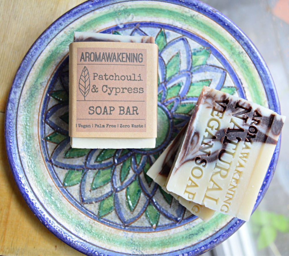 Patchouli & Cypress Soap on a green and blue ceramic plate. The soap label