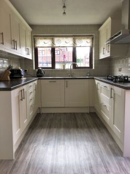 Photo of a cream, shaker kitchen with LVT flooring