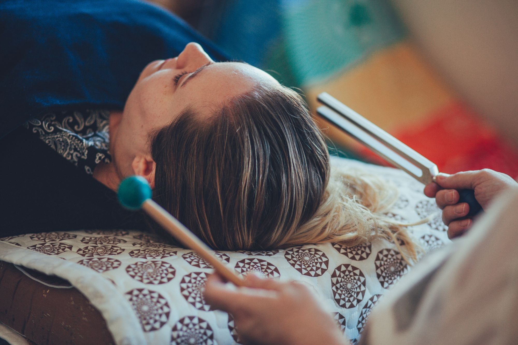 Woman on couch receiving tuning fork therapy