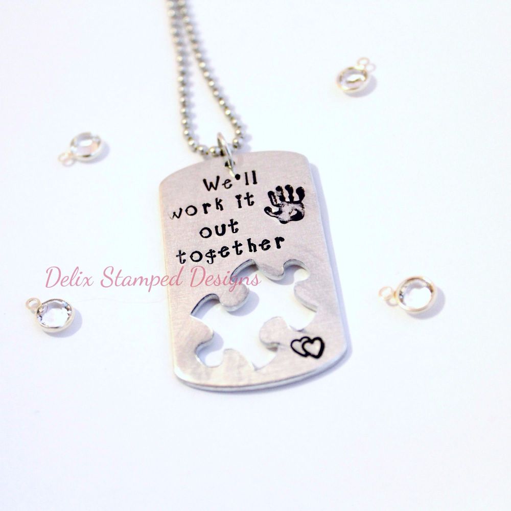 Hand stamped dog tag with missing puzzle piece