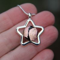 Pale pink and black dichroic star pendant