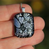 Silver tumbling hearts dichroic glass pendant
