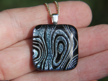 Pale silver green swirl pattern dichroic glass pendant