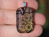 Gold  and pink whorls dichroic glass pendant