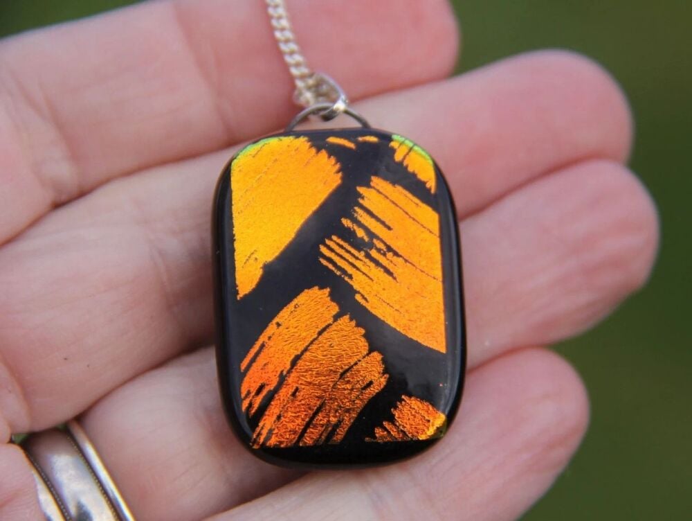 Reversible orange brush green fish dichroic glass pendant