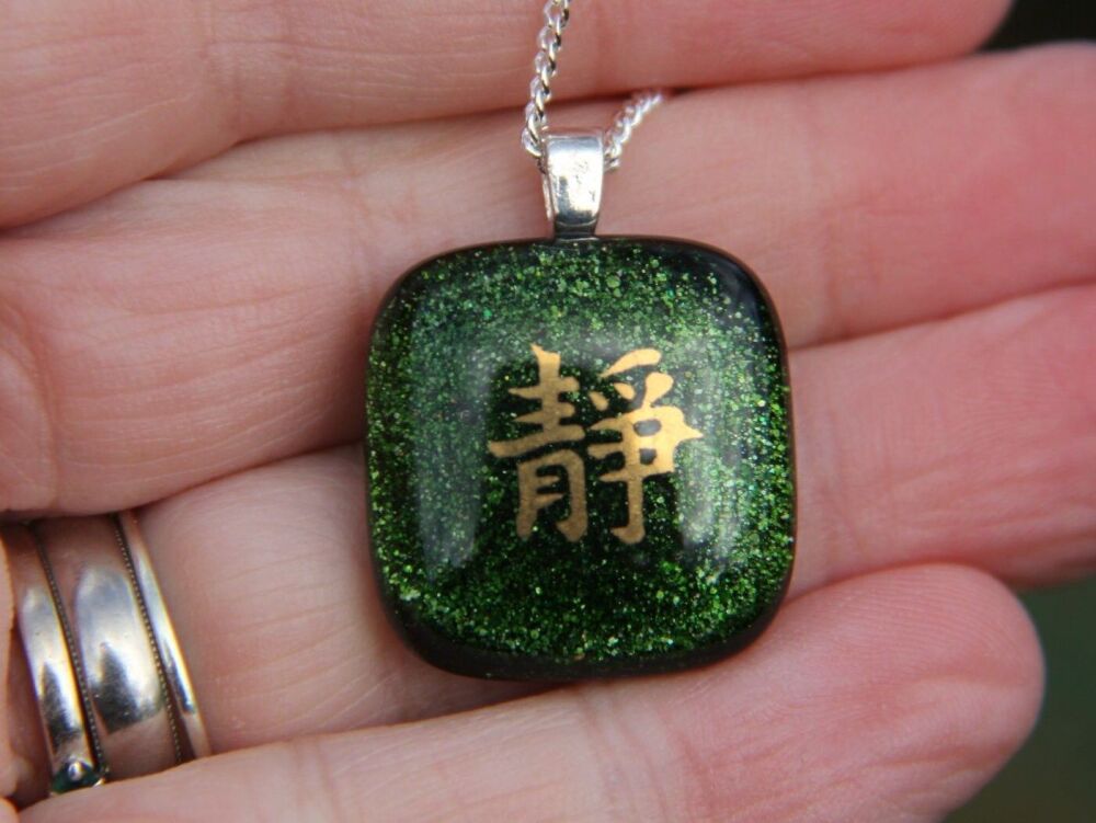 Green sparkly glass pendant Chinese symbol 'Tranquility'