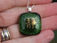 Green sparkly glass pendant Chinese symbol 'Tranquility'