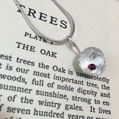 Solid silver acorn cup with garnet pendant