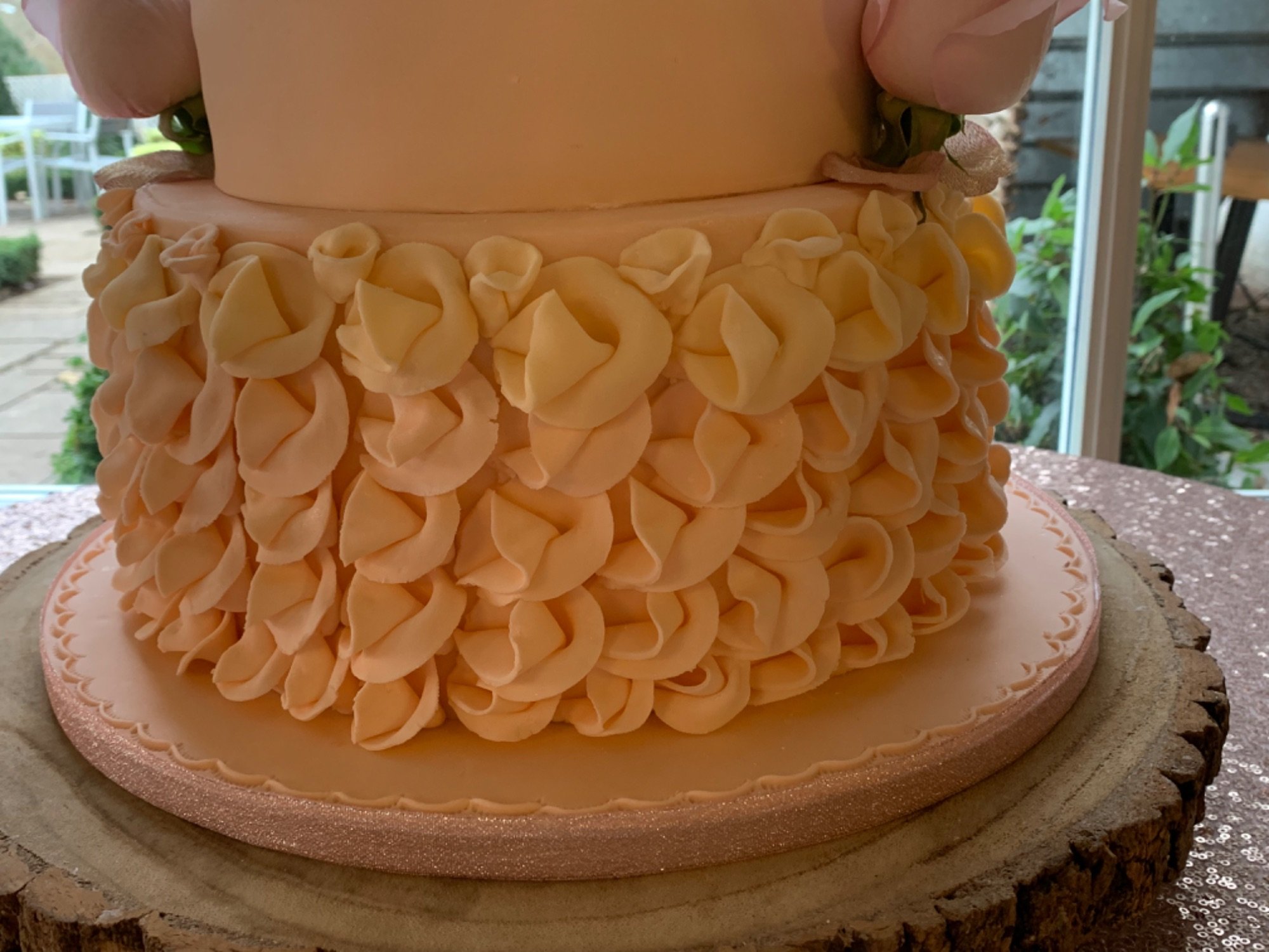 Peach ruffled wedding cake