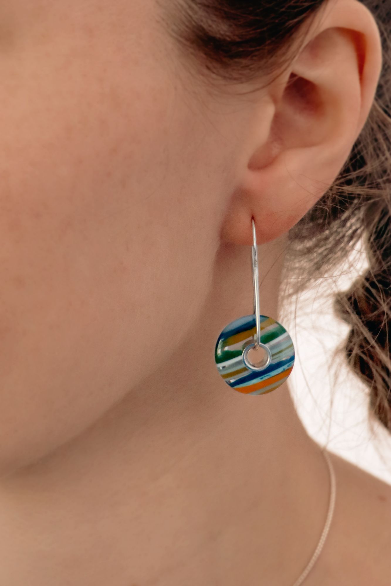 Women wearing a round striped earring