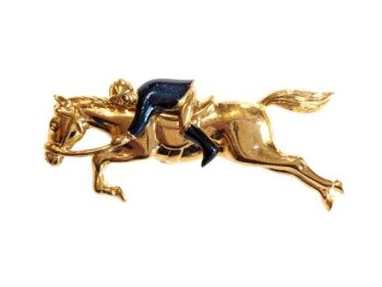 Vintage Cabouchon  brooch  with a galloping horse and a jockey with gold plating and black enamel