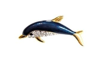 Vintage Cabouchon  gold plated dolphin brooch with blue enamel and Austrian crystals. The eyes are black.