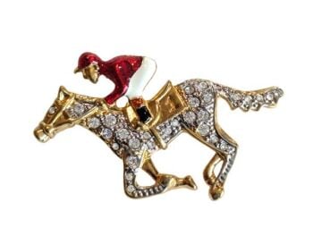 Vintage Cabouchon brooch depicting a horse and a jockey with gold plating, red and black enamel and Austrian crystals.