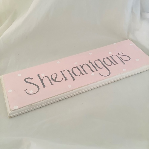 Sign ‘shenanigans’ pink with spots