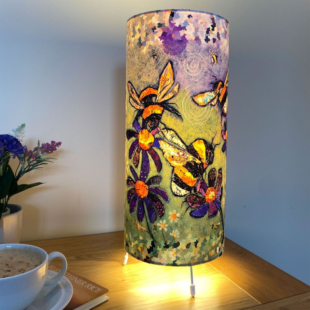 Humble Bumbles Cylinder Table Lamp on purple, yellows and greens