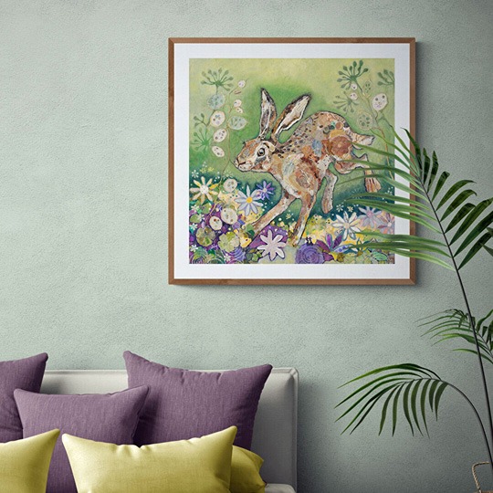 hare fine art print by Dawn Maciocia featuring a leaping hare which is hanging on a wall in a room setting
