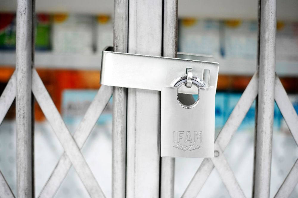 HEAVY DUTY HASP AND STAPLE GATE GUARD PLUS MAX50 CORROSION RESISTANT PADLOCK.