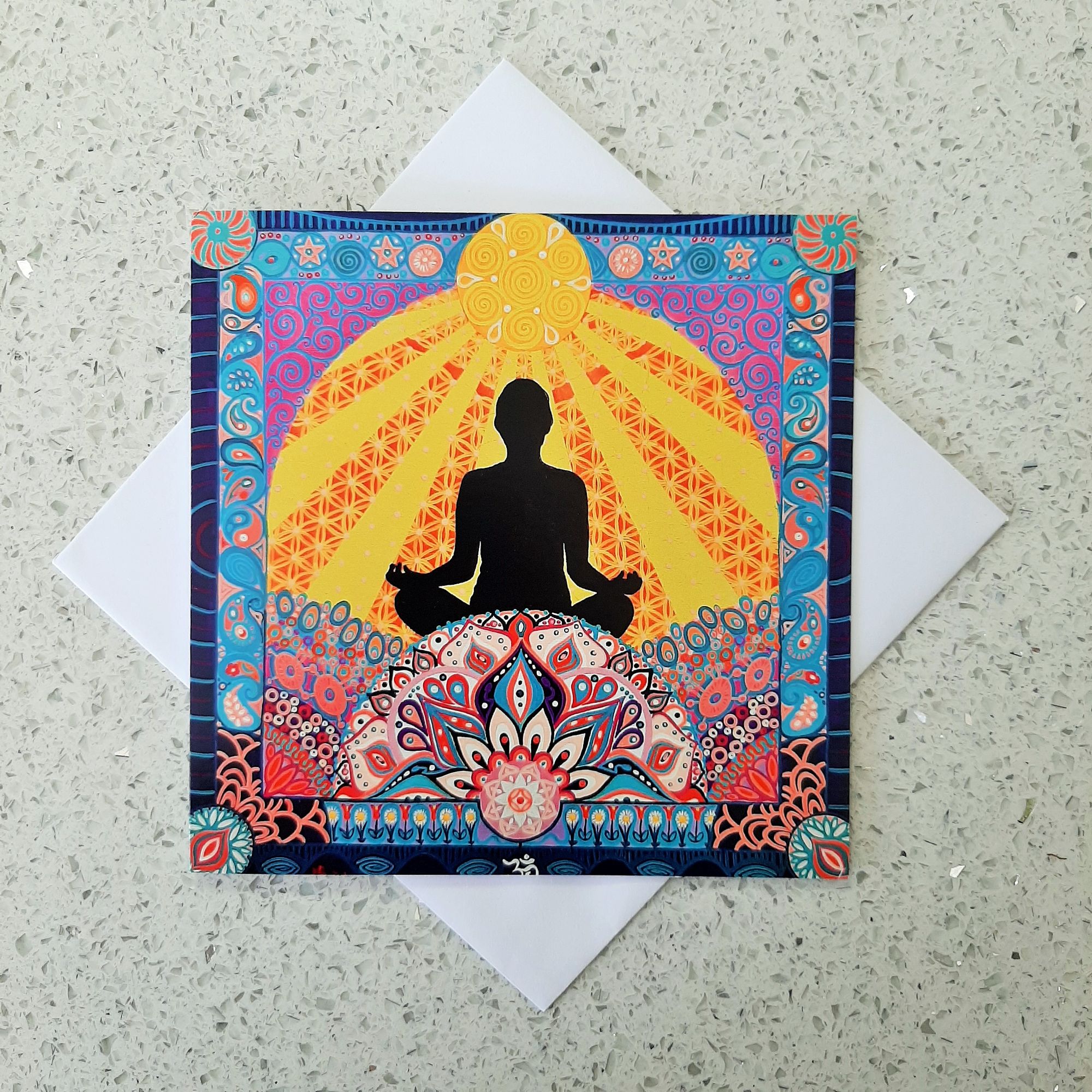 Greetings card featuring a meditating person sat beneath a sun and it's rays, amongst a mindful  landscape