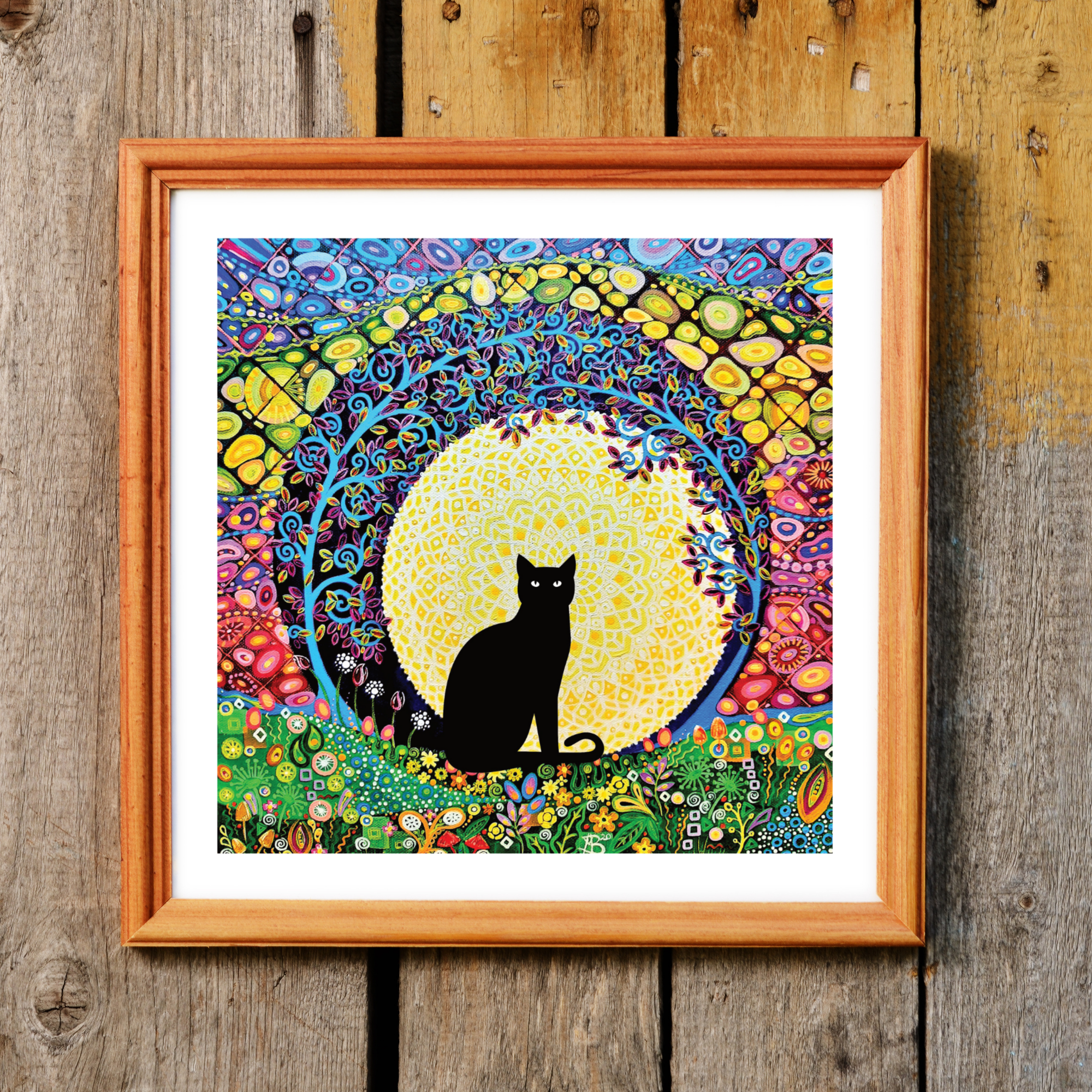 A colourful black cat, tree of life and full moon art print, download and printable at home, in a wood effect frame (not included to buy).