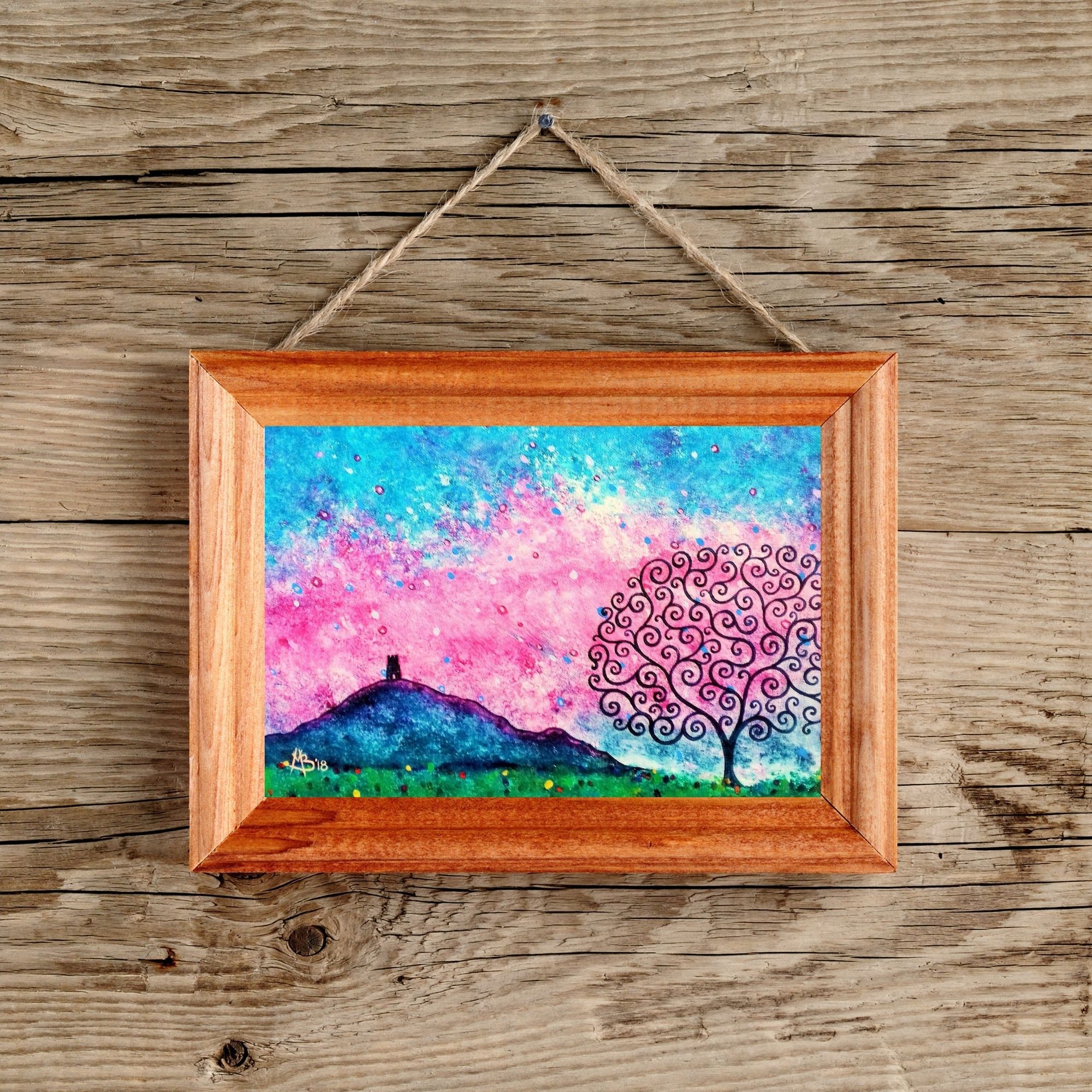 Colourful purple and pink Glastonbury Tor and Tree of Life art print, down;oad and print at home, in a wood effect frame (not available to purchase)