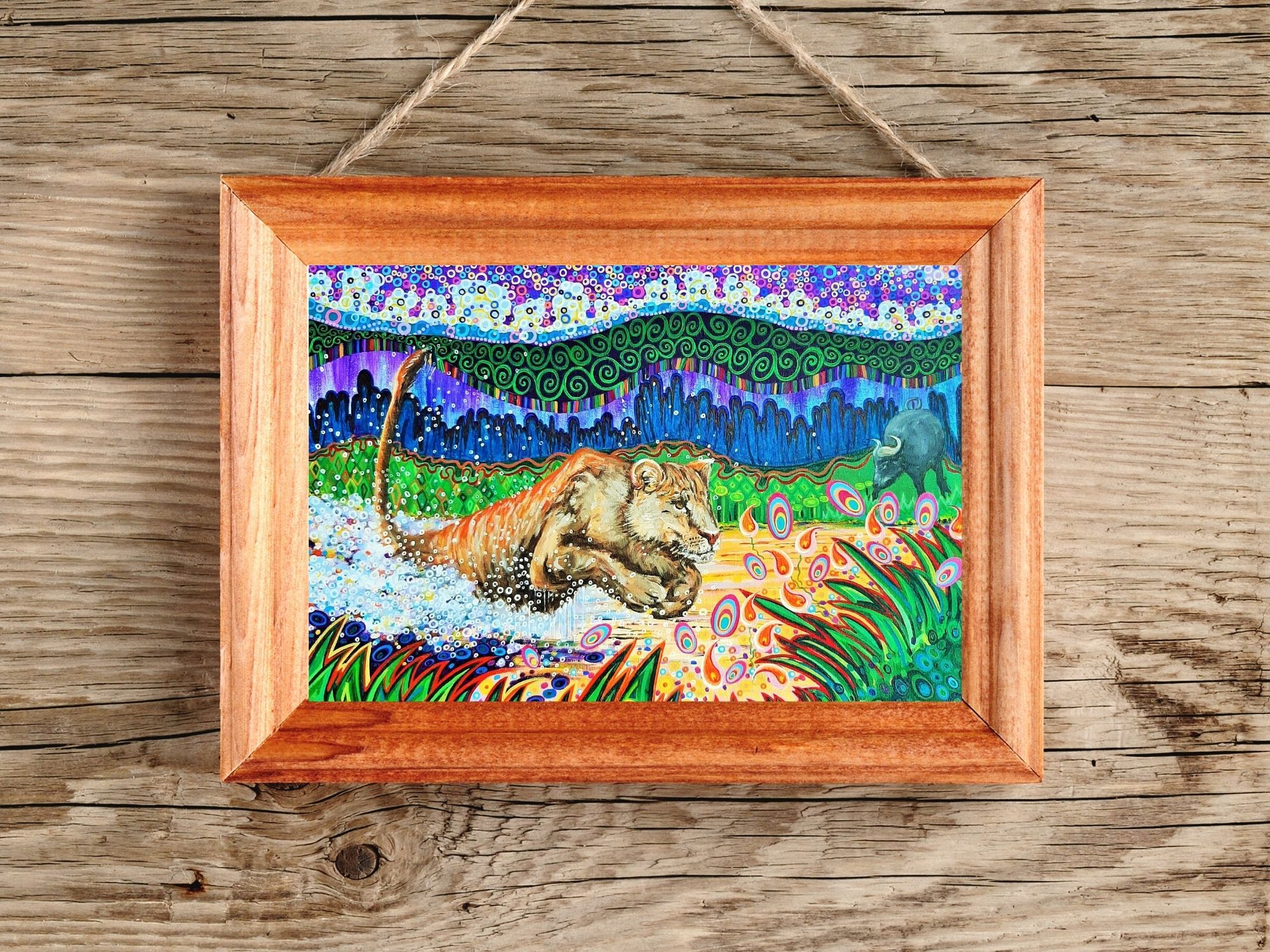 Colourful lion art print, download and print at home, in a wood effect frame (not available to purchase).