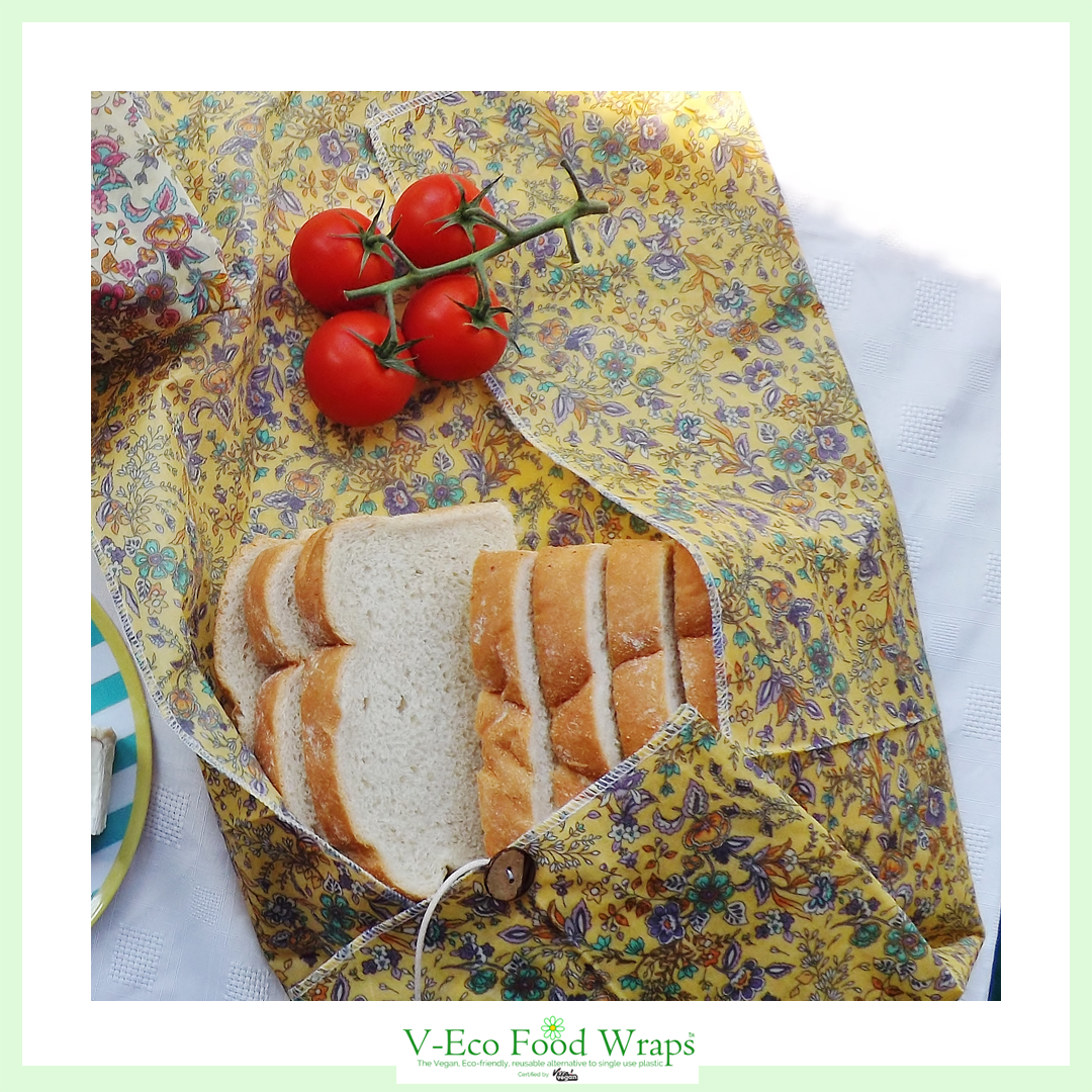 V-Eco Food Wrapsâ„¢,  LoafLover â„¢- waxed fabric food wrap around loaf of bread alongside tomatoes on the vine 