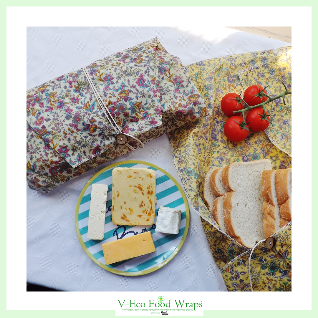 V-Eco Food Wrapsâ„¢,  LoafLover â„¢- 2 waxed fabric food wraps around loaves of bread alongside cheese and tomatoes