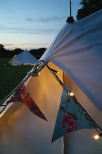 Bell tents at dusk at Oddhouse Farm Glamping