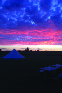 sunset with glamping tents